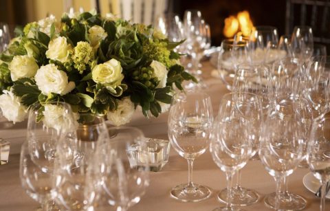 close up of glassware setting with floral centerpiece during the Valentine's Day Dinner in the dining room at Jordan Winery