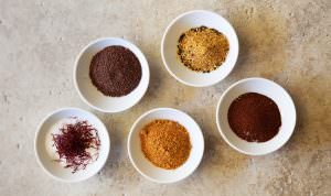 5 small bowls of different colored spices