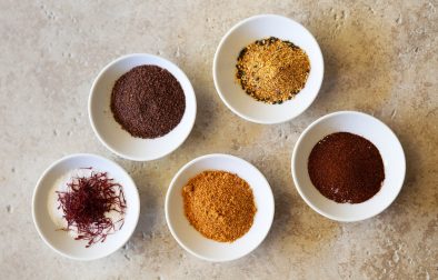 5 small bowls of different colored spices