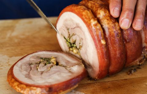 knife slicing the cooked Jordan Winery Herb Roasted Pork Belly Porchetta