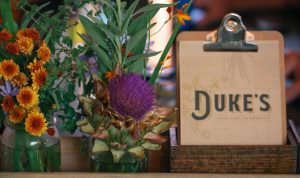 The Duke's Spirits & Cocktails Bar Menu next to flowers