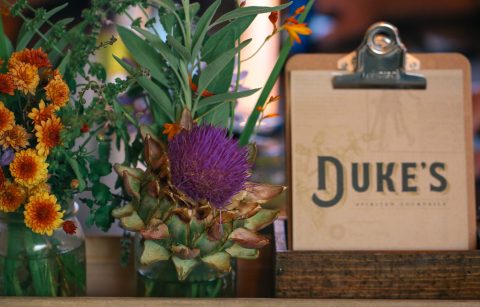 The Duke's Spirits & Cocktails Bar Menu next to flowers