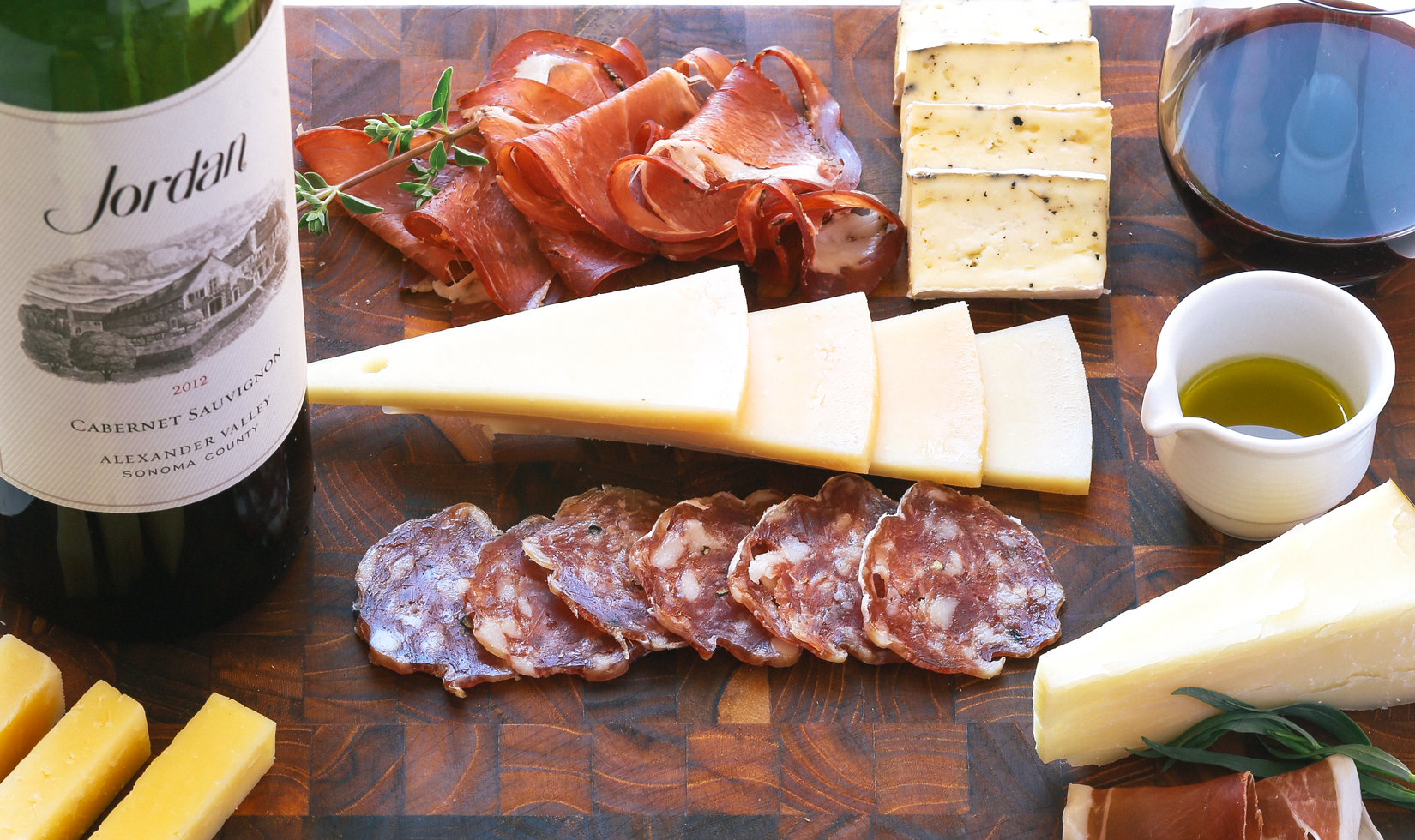 a charcuterie board with cheeses and cured meats