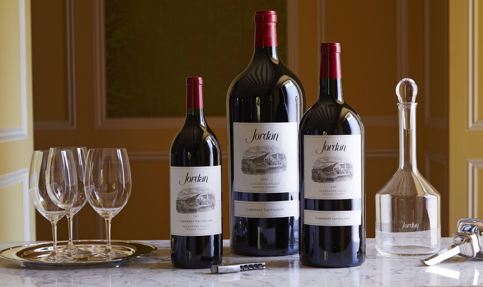 3 different sizes of wine bottles from Jordan Winery. 