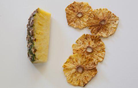 slice of pineapple next to slices of dehydrated pineapple