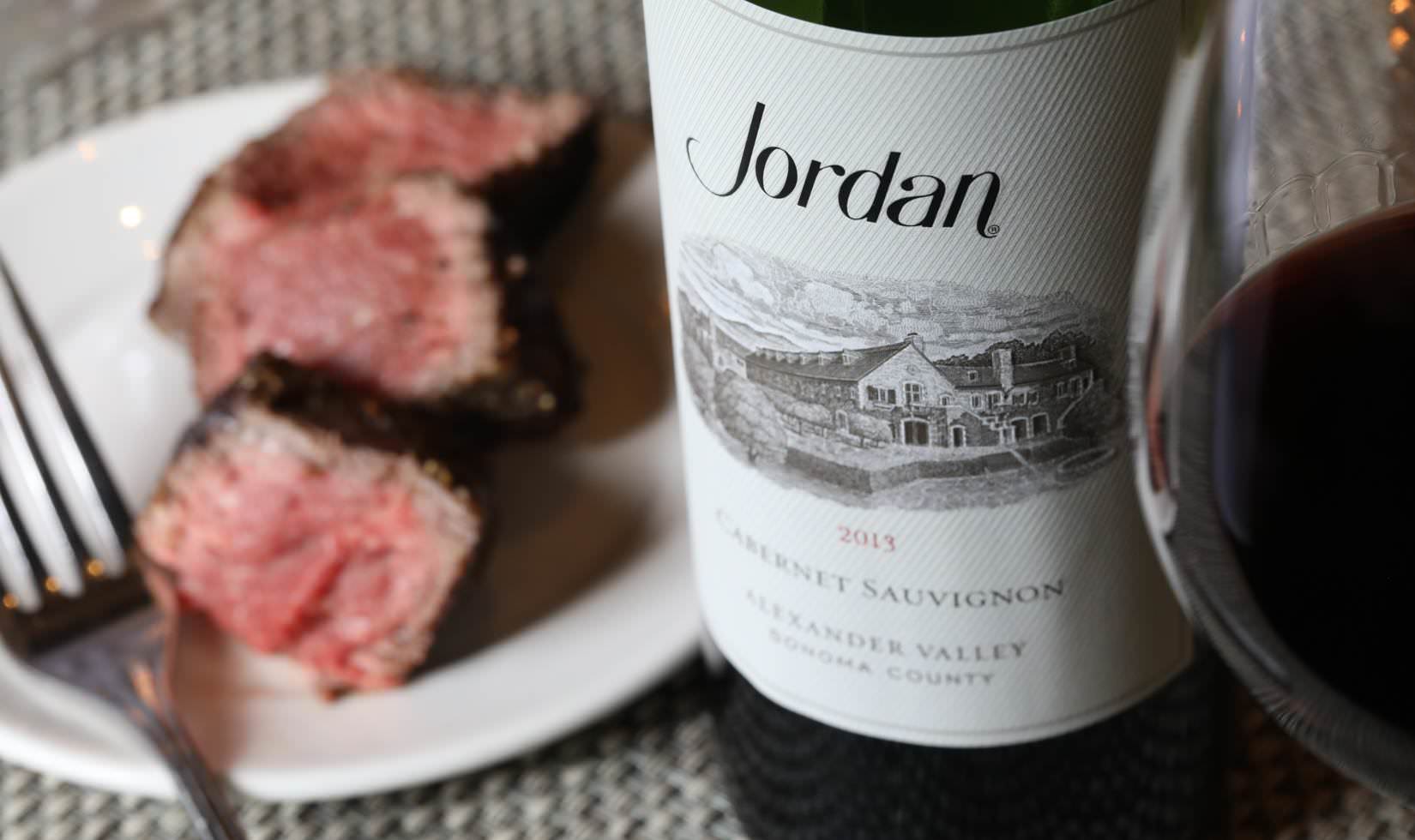 Slices of ribeye on a plate ready to pair with a more fruit-forward, younger cabernets, like 2013 Jordan Cabernet Sauvignon.