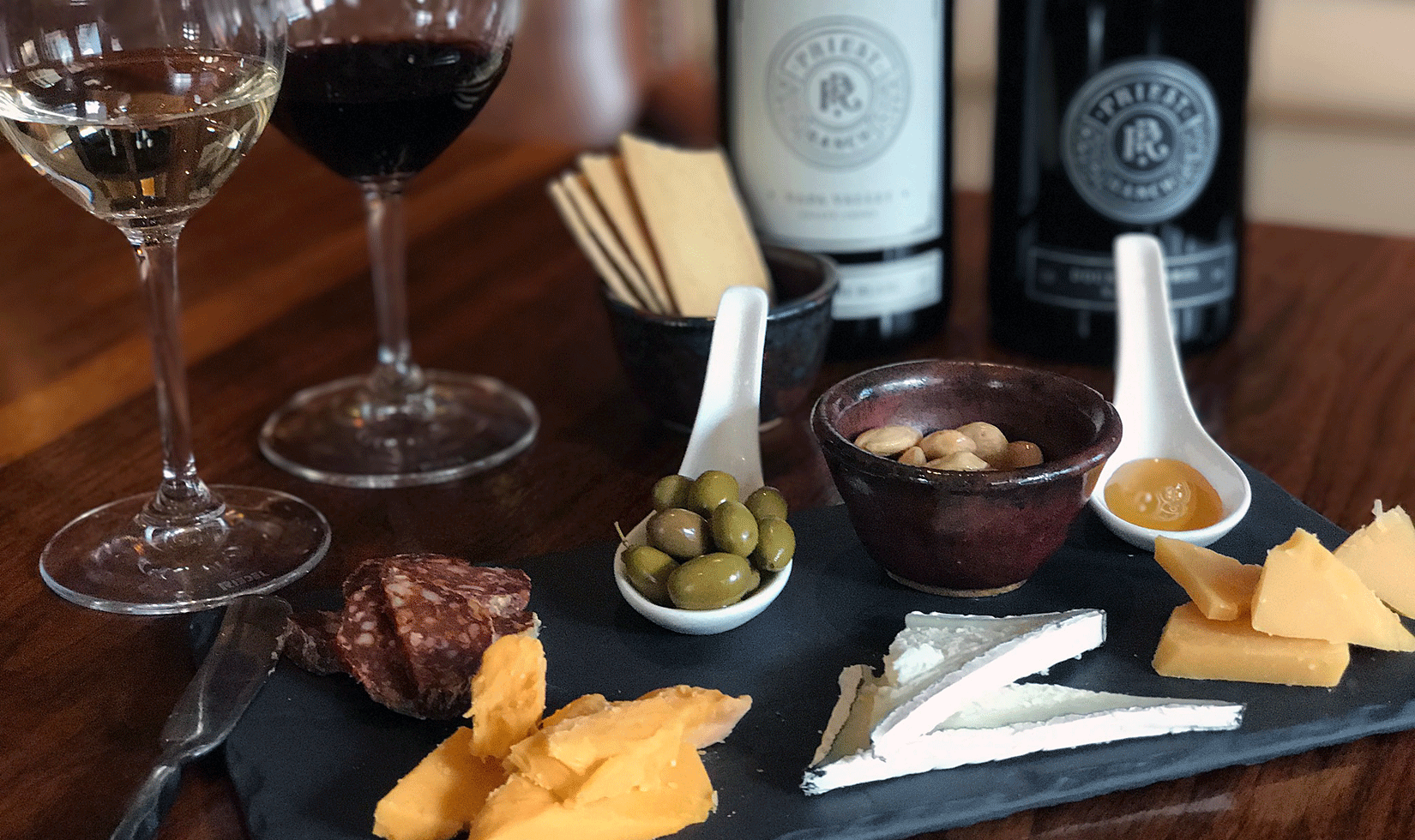 cheese and wine tasting with pickles, bread and biscuits
