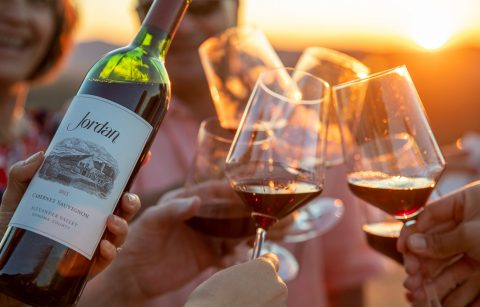 wine glass toast at sunset supper event at Jordan Winery with Jordan Winery Cabernet