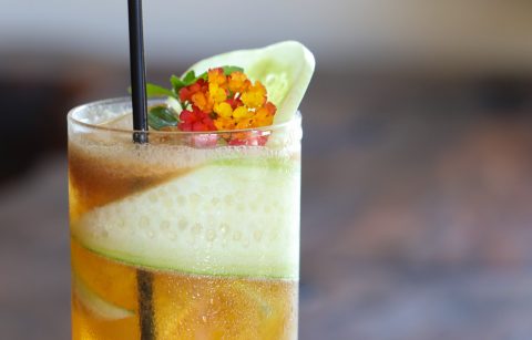 "Pimm's Cup" cocktail with edible flower and cucumber from Geyserville Gun Club