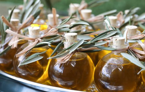 Jordan Winery extra virgin olive oil in glass bottles with olive leaf sprig garnish