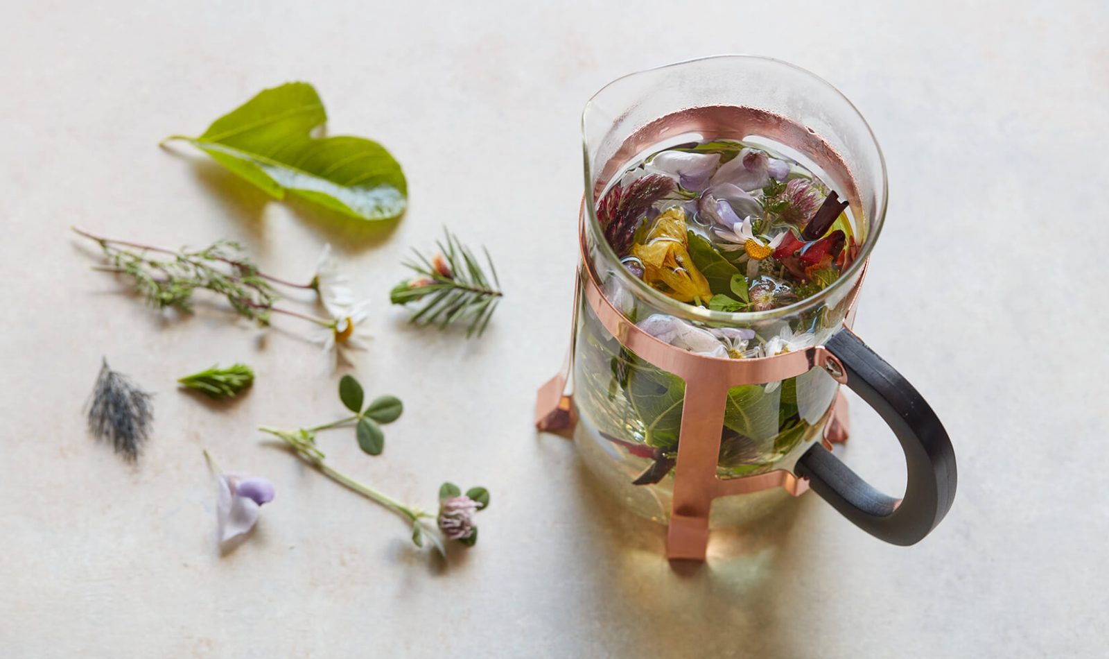 Jordan Winery Nasturtium tea in tea press with additional ingredients laid out.