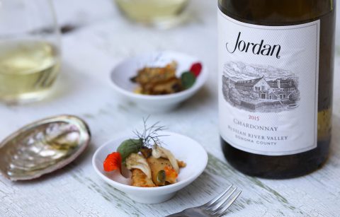 abalone food bite next to a bottle of Jordan Chardonnay