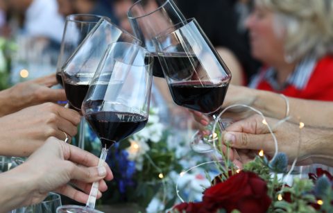 guests toasting with glasses of red wine at a Bastille Day event at Jordan Winery