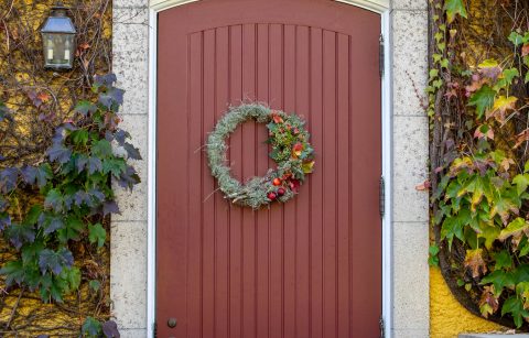 fall wreath on a red door at Jordan Winery