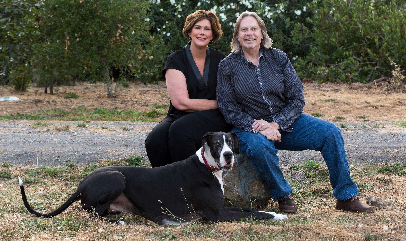 Portrait photograph of Bob and Heather Cabral with their dog.