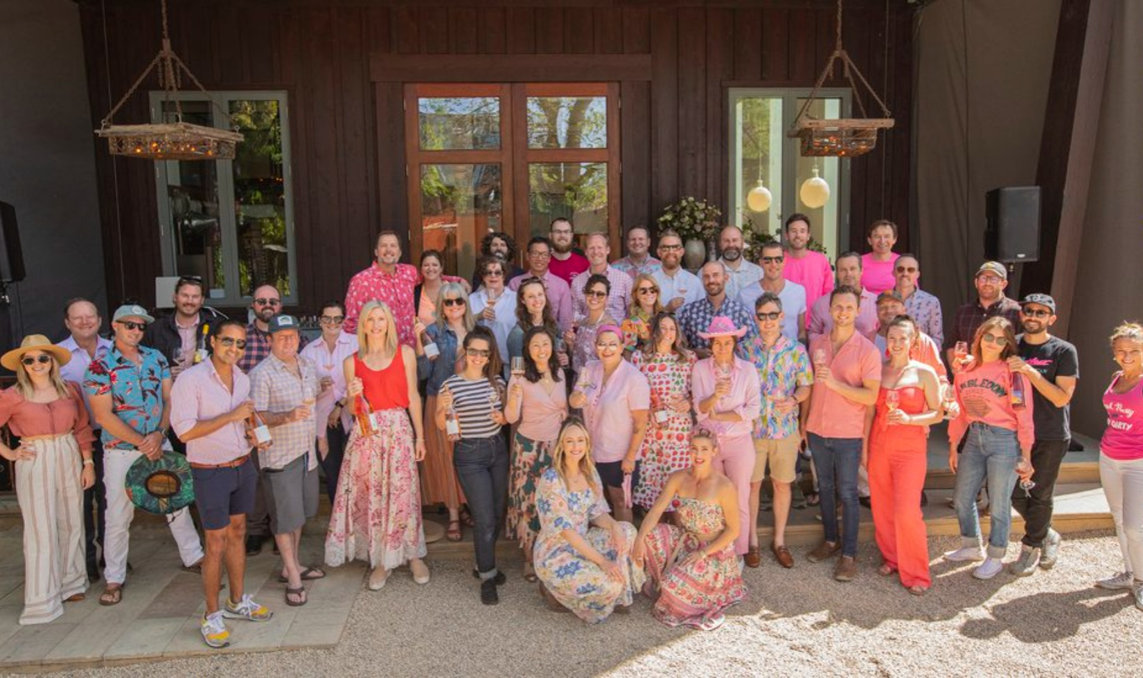 Group dressed in pink with rose wine at Barndiva