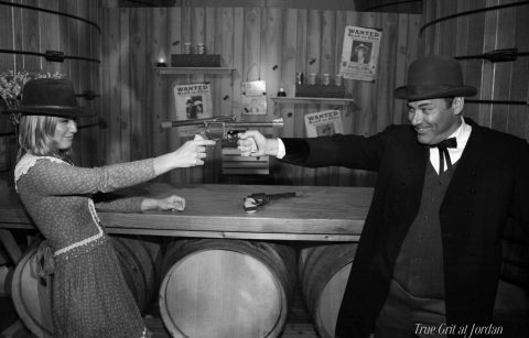 black and white photo of guests posing in costume at a True Grit themed halloween party at Jordan Winery