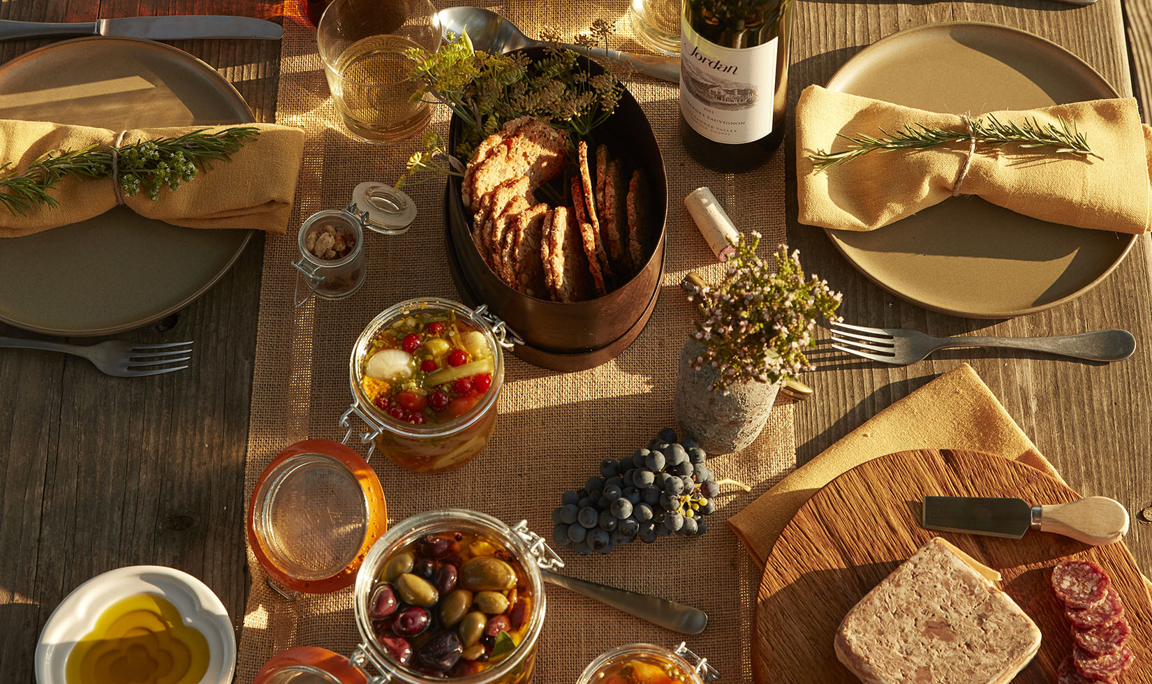 Marinated olives, pickled vegetables and spiced nuts in mason jars with Jordan Cabernet Sauvignon for a picnic