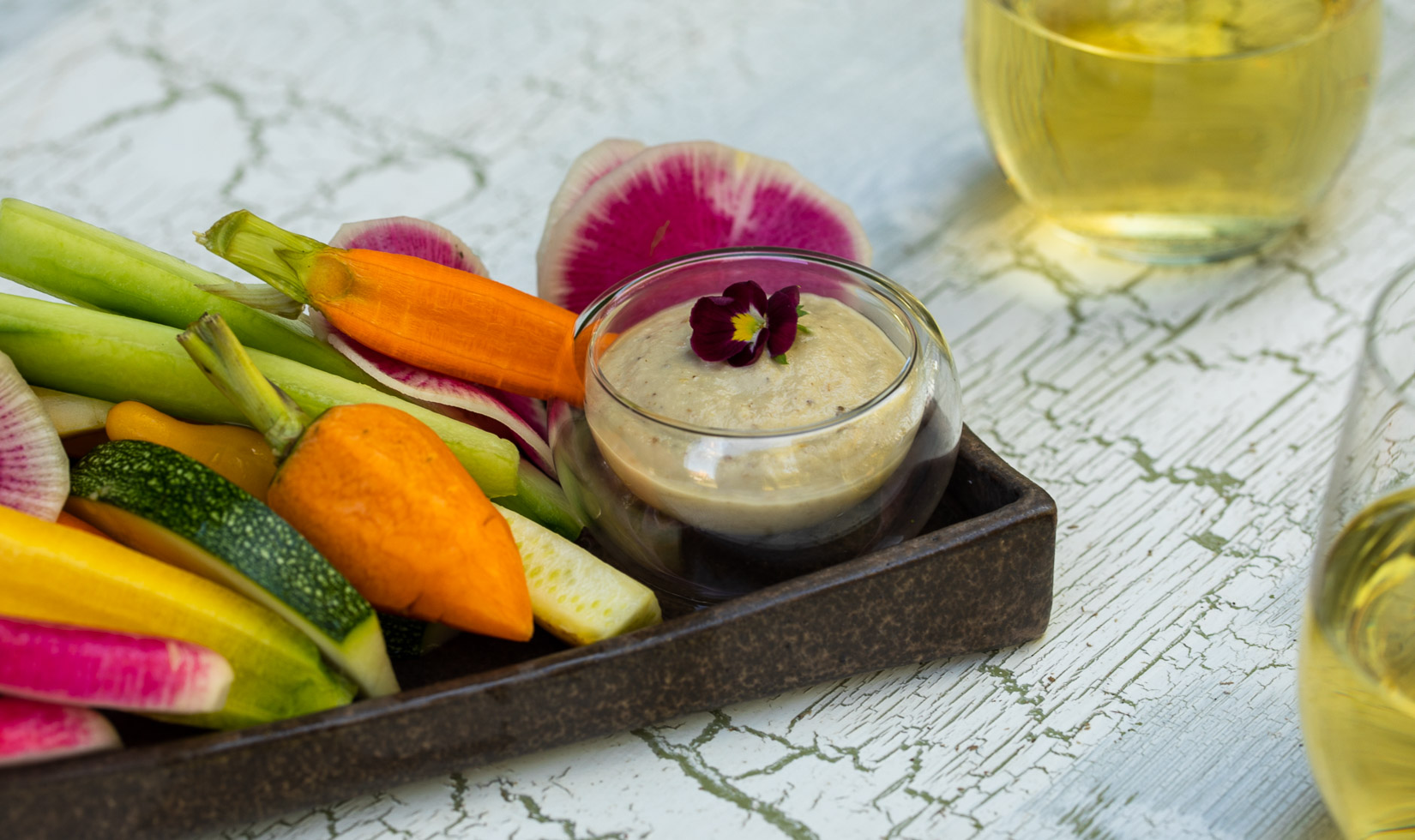 Grilled eggplant baba ganoush on plate with crudite for edible centerpiece