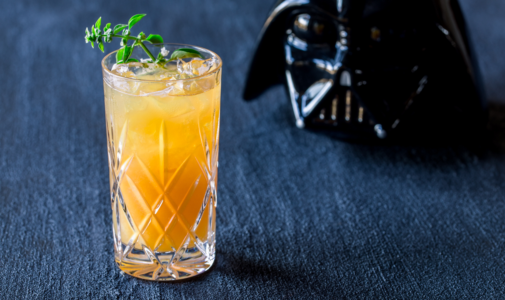 Dark and Stormy Trooper Halloween cocktail with Darth Vader helmet in the background