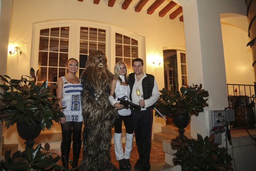 Guests dressed up for a Jordan Winery Star Wars Halloween party posing in Jordan's Oak Tank Room.