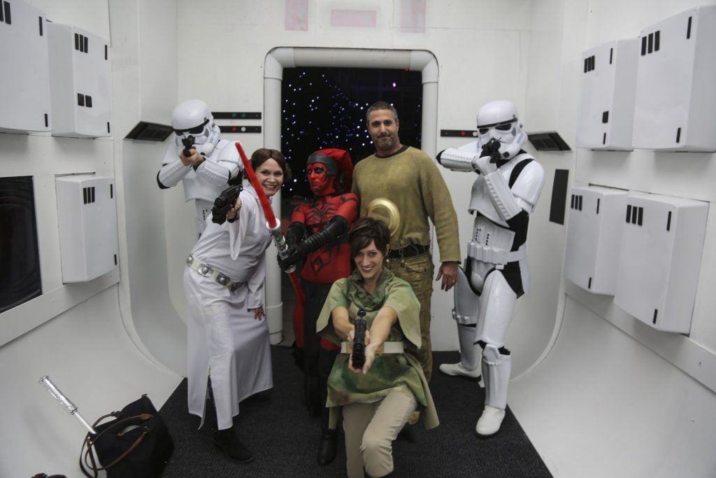 Guests dressed up for a Jordan Winery Star Wars Halloween party posing with stormtroopers.