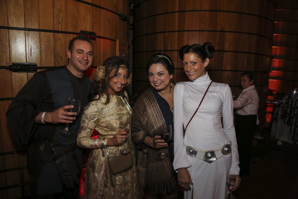 Guests dressed up for a Jordan Winery Star Wars Halloween party posing in Jordan's Oak Tank Room.