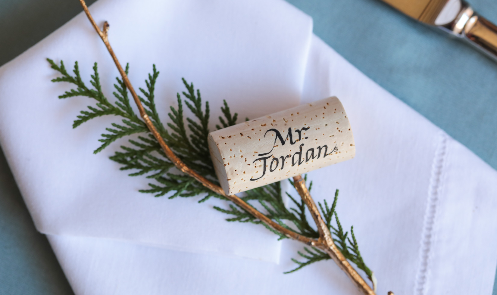 cedar spring and gold branch with custom cork calligraphy name tag place setting with custom