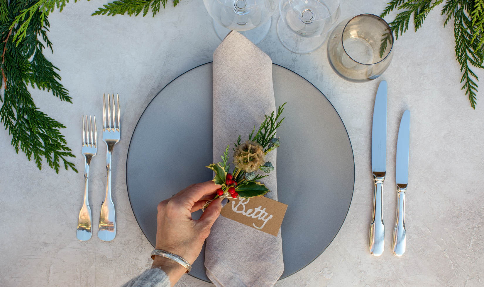 scabiosa pods and holly place setting for christmas table