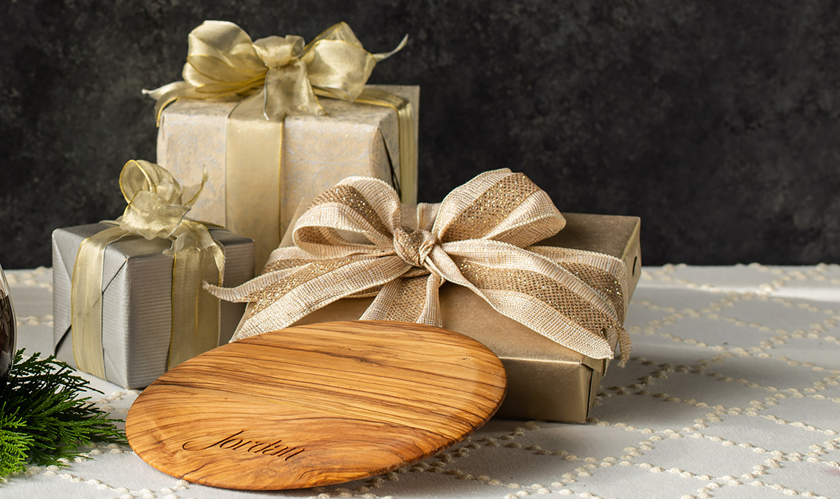 olive wood cutting board by Jordan Winery on table with presents