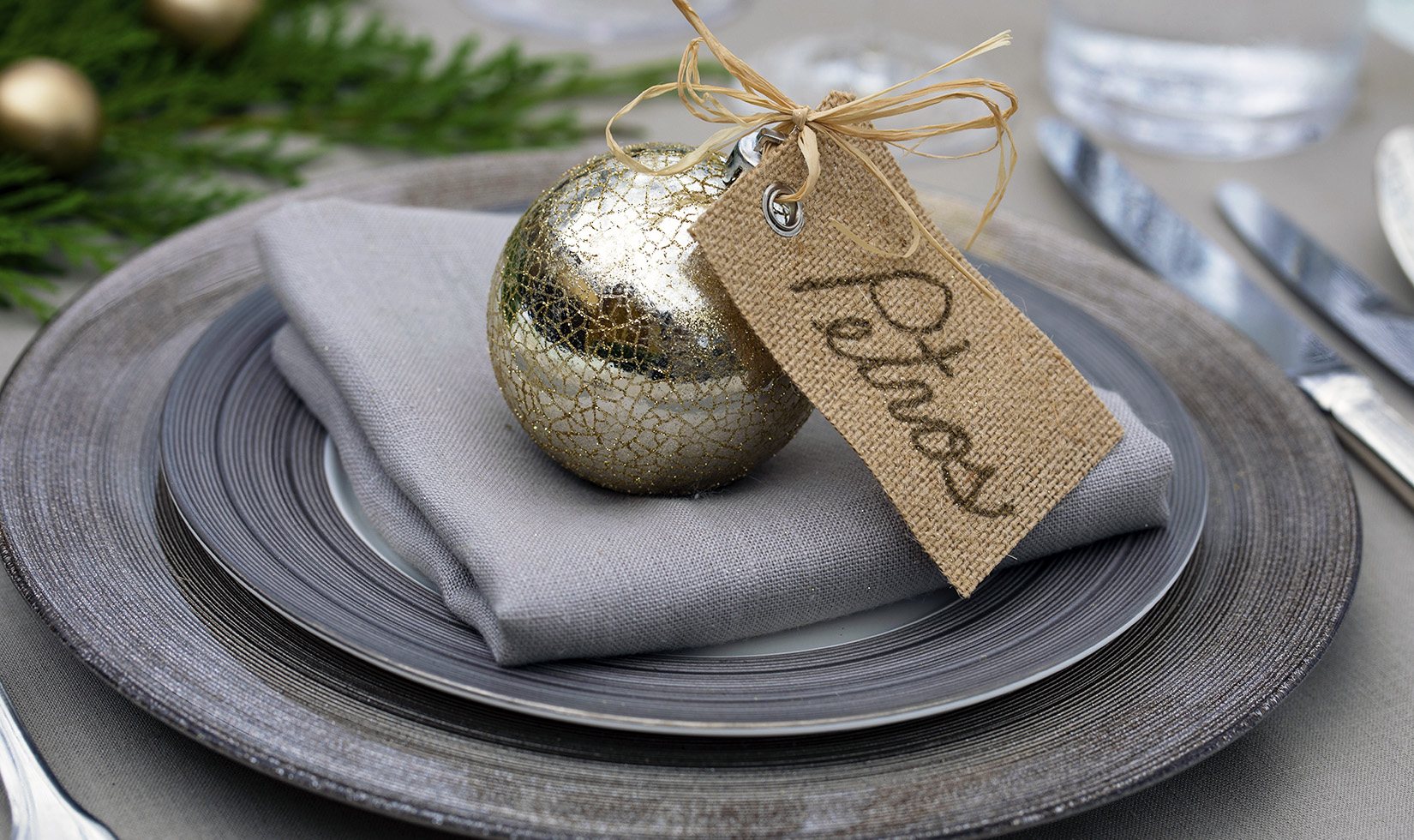 Christmas ornament table setting on silver and gold plate