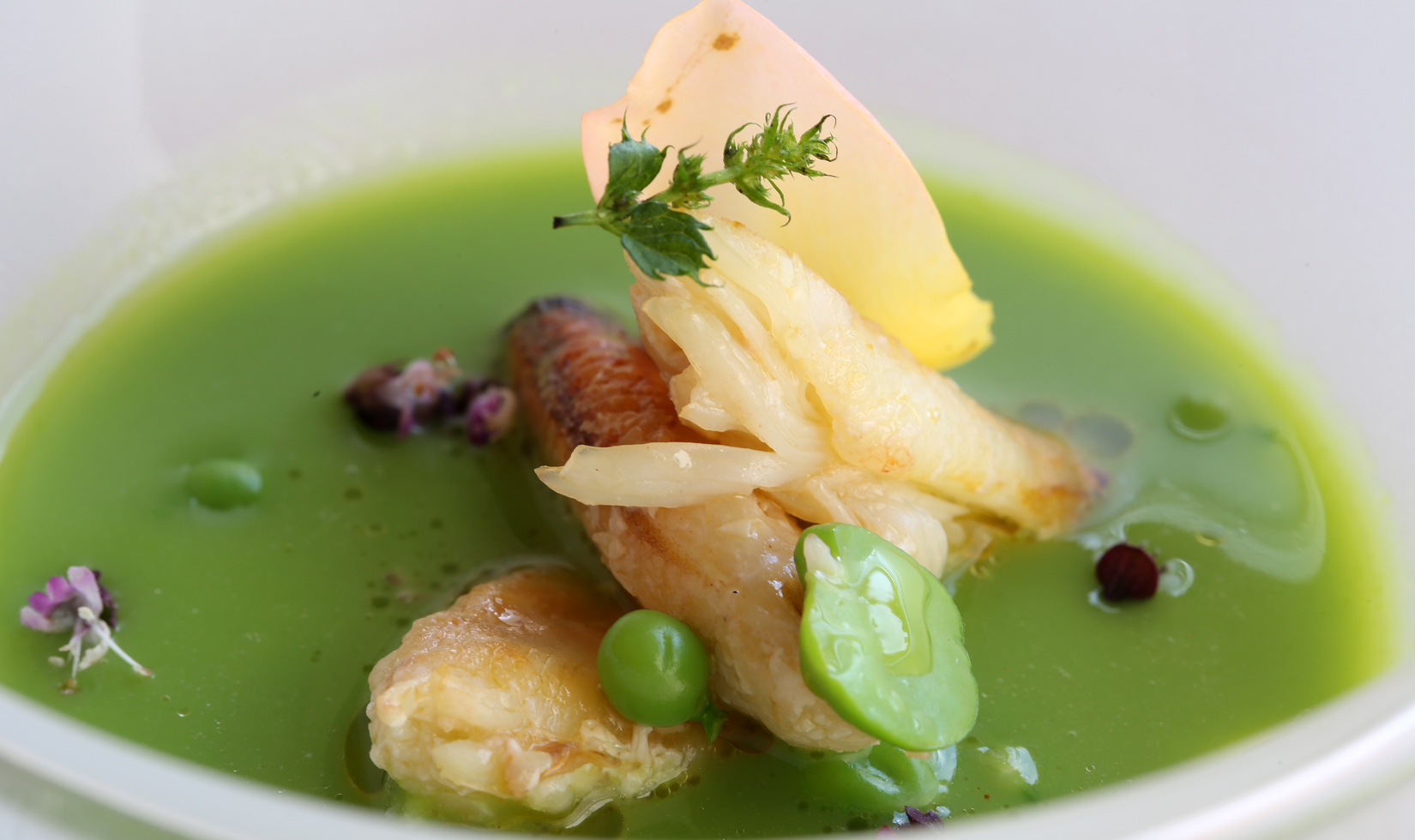 Jordan Winery pea soup with dungeness crab in white bowl