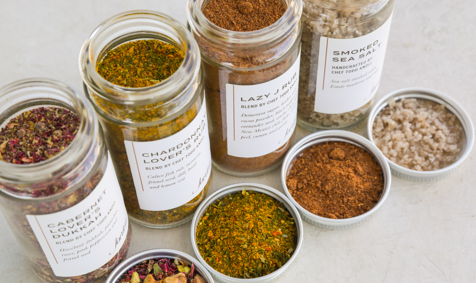 four containers of spice blends