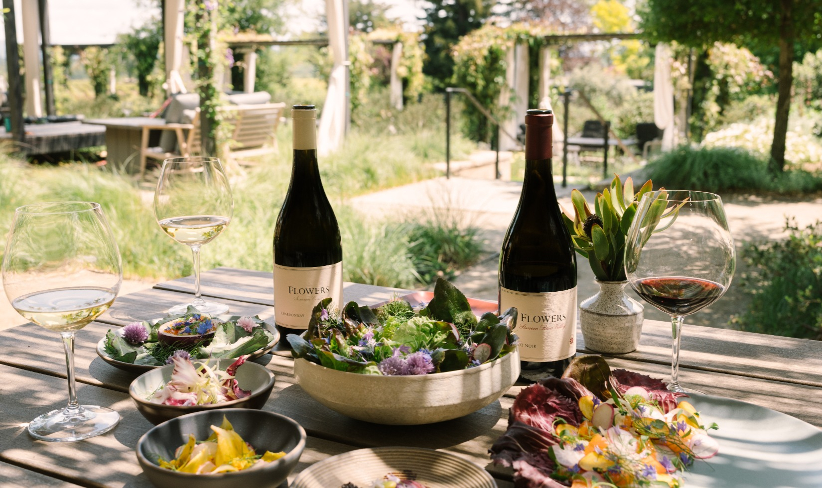 Outdoor table set with wine and food pairing at Flowers.