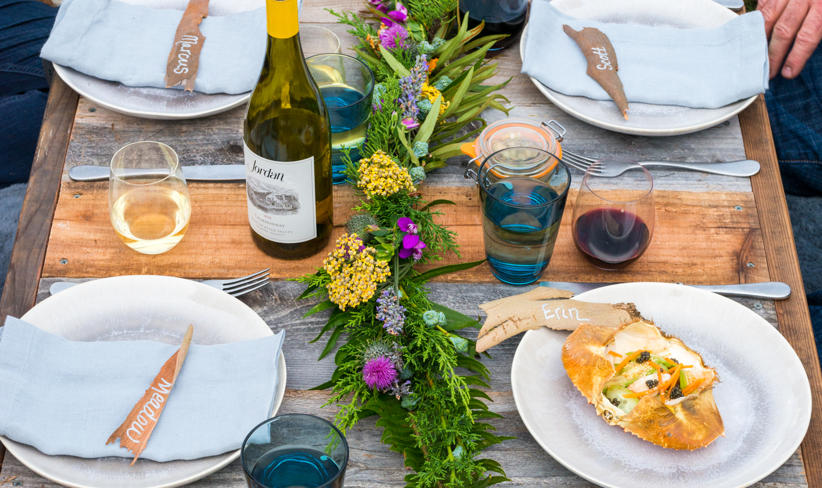 wine country picnic tablescape with floral centerpiece