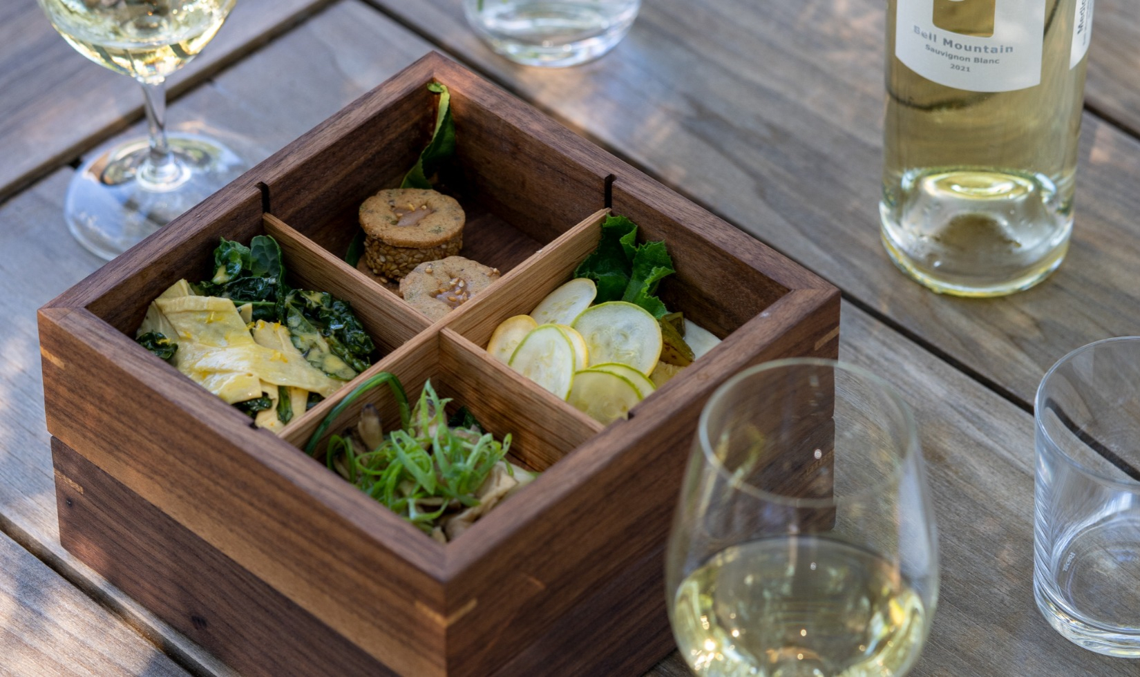 bento box lunch with glass of sauvignon blanc 