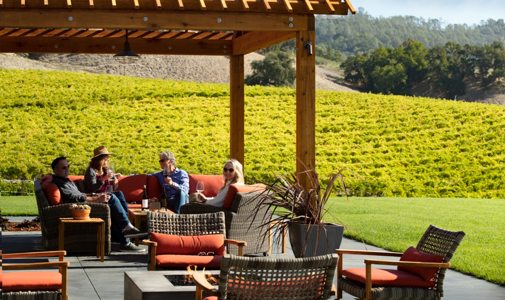 Group on winery terrace on outdoor couches wine tasting