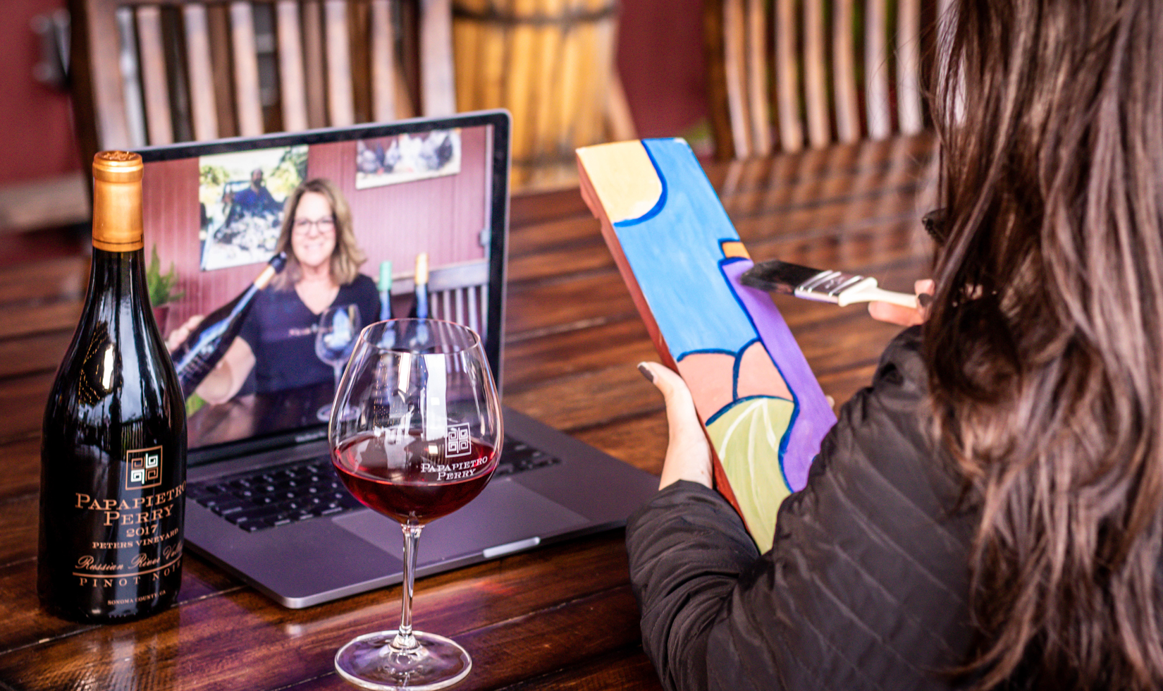 virtual wine tasting and painting class with laptop and wine glasses