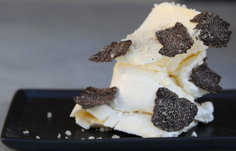truffle butter sprinkled with sea salt on black plate