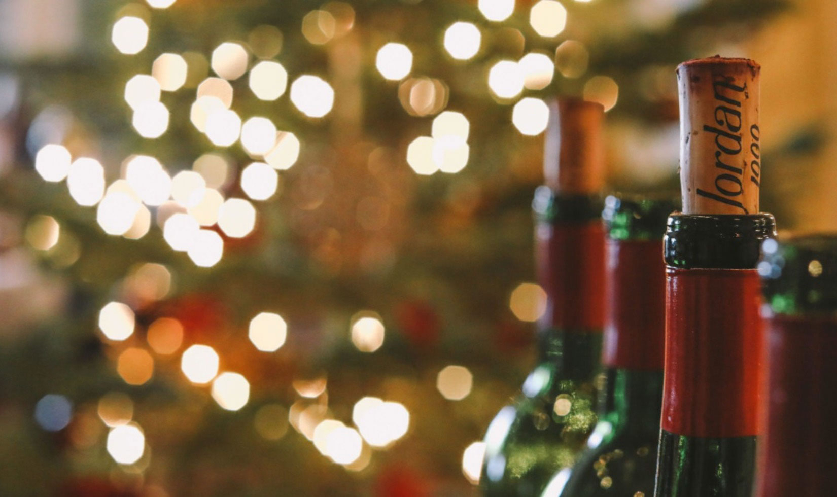 Jordan Cabernet bottle necks with corks in front of Christmas lights