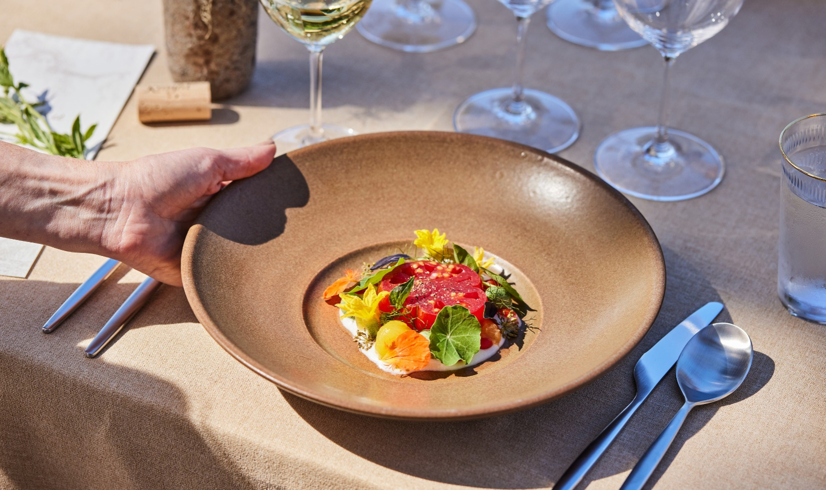 Elegantly presented dish served on a ceramic dish served on outdoor terrace table