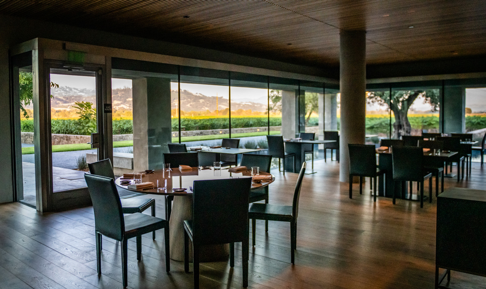 restaurant with empty tables and chairs and vineyard views