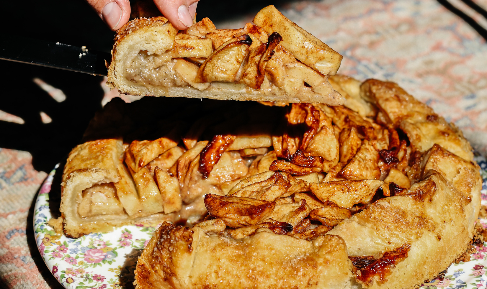 knife cutting into an apple galette 