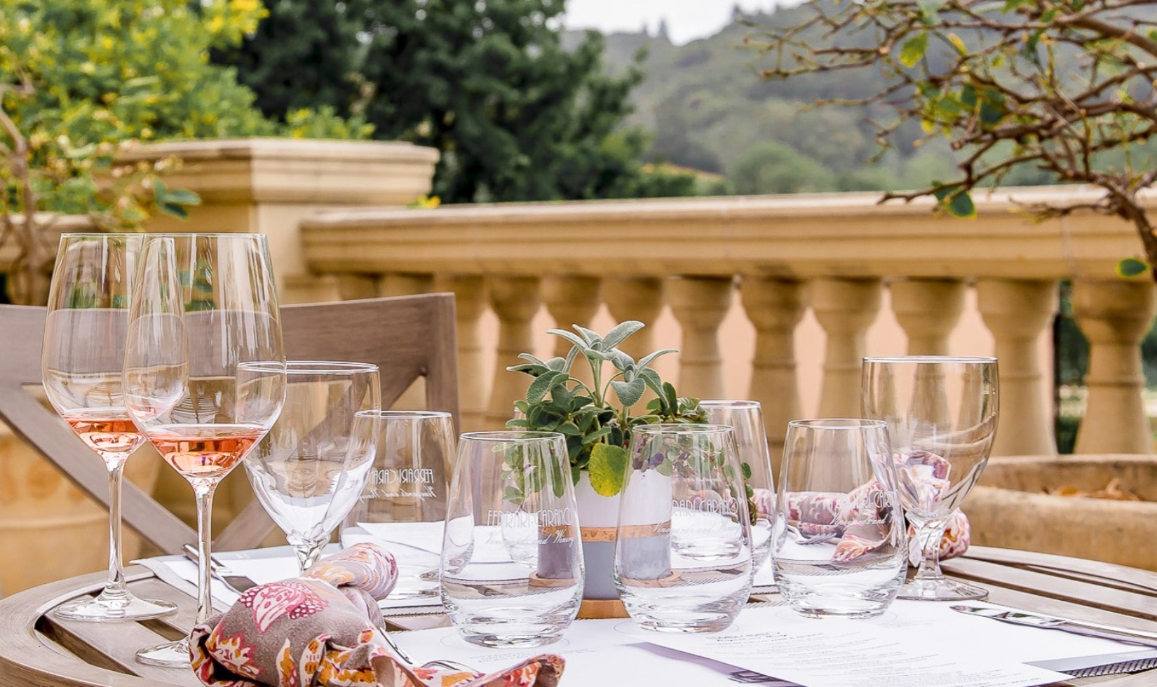 Table on terrace of winery estate in Italian villa style