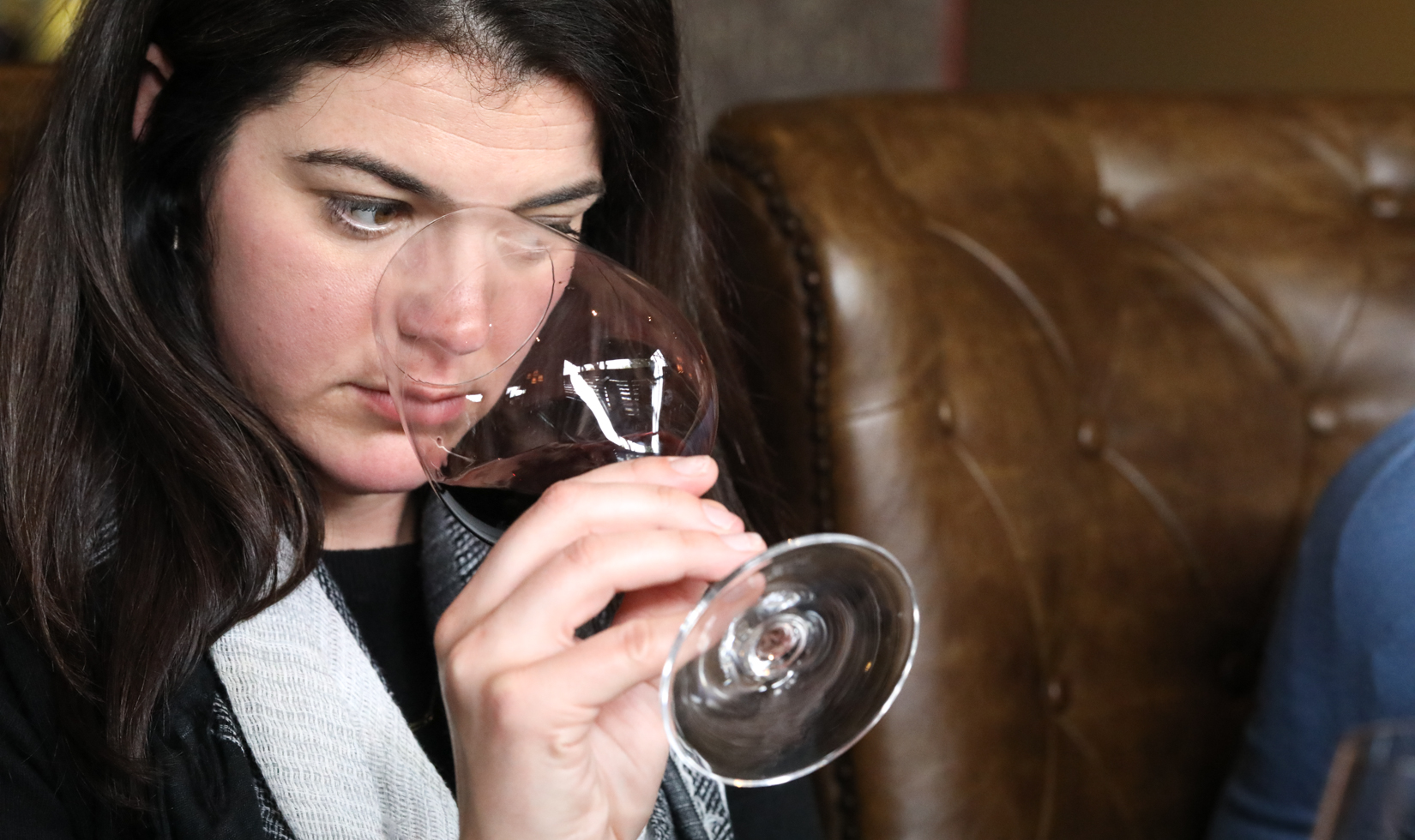 woman sniffing aromas from wine glass 