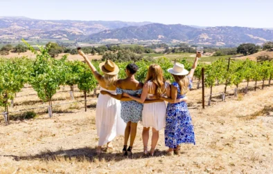 4 women celebrating their wines in the vineyard