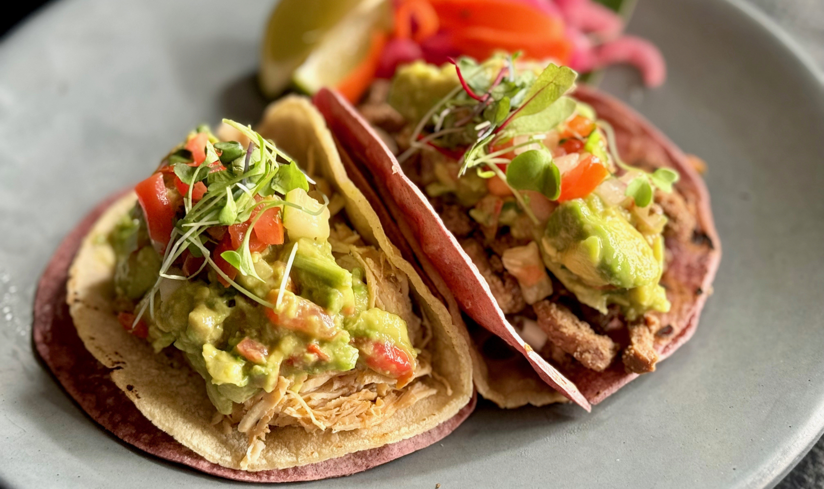 Close up image of tacos al carbon with guacamole 