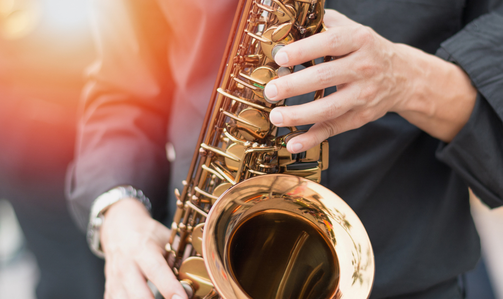 close up of man playing saxophone