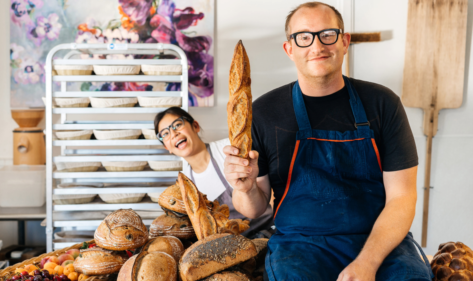 Quail and Condor owners Melissa Yanc and Sean McGaughey in bakery kitchen with loaves of bread