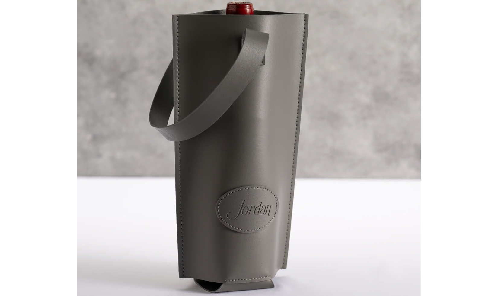 Gray Jordan-branded leather wine tote with a bottle inside.